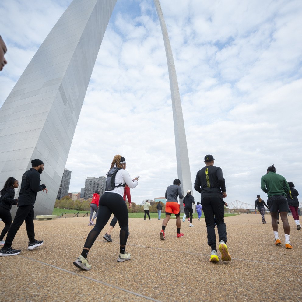 People running under the Gateway Arch